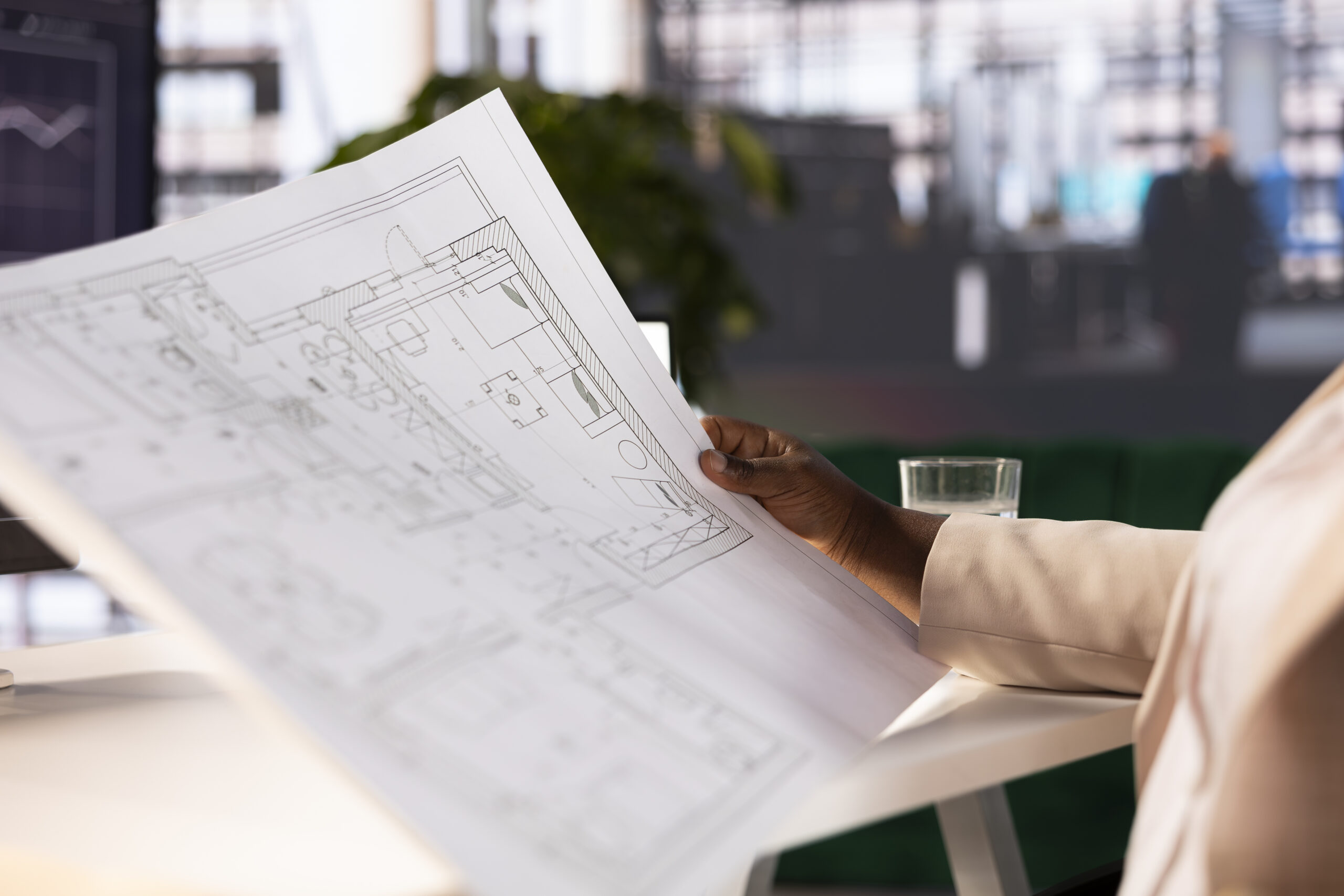 architect finishing home schematics after collaborating with engineers